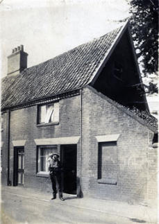 Edwin Cop outside dwelling next to Peake's shop